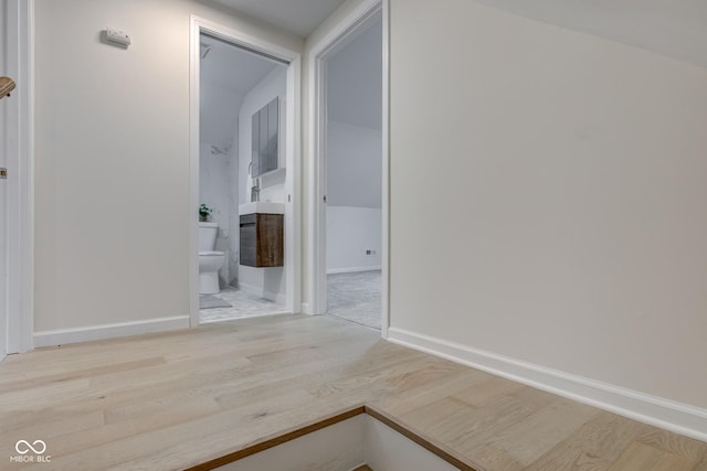 interior space featuring wood finished floors and baseboards