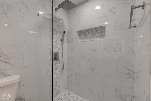 full bath featuring a marble finish shower and toilet