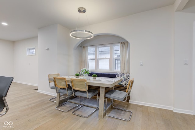 dining room with breakfast area, light wood-type flooring, and baseboards