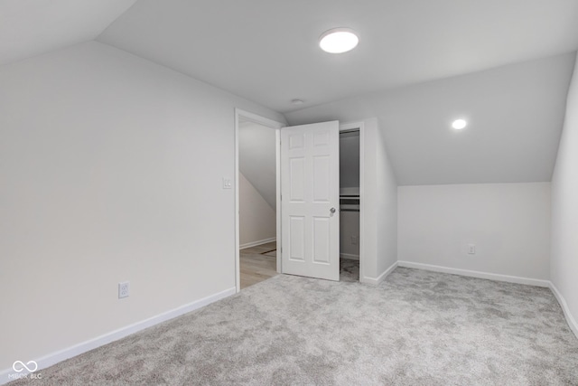 bonus room with lofted ceiling, carpet floors, and baseboards