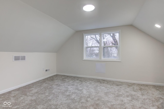 bonus room with vaulted ceiling, carpet, visible vents, and baseboards