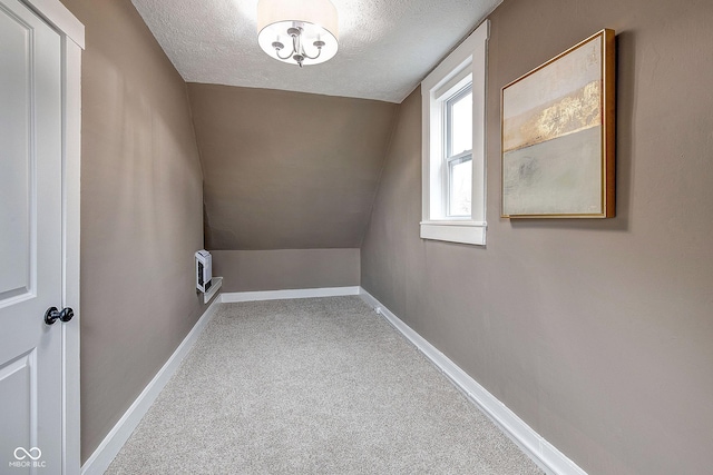 washroom with carpet flooring, a textured ceiling, and baseboards