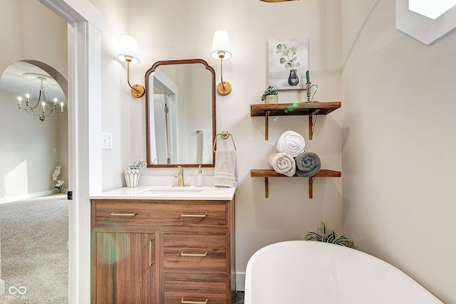 bathroom featuring a soaking tub, vanity, and baseboards