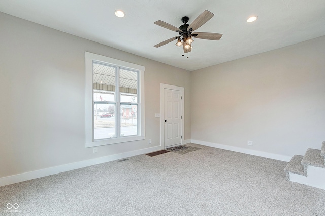 empty room with carpet floors, recessed lighting, visible vents, and baseboards