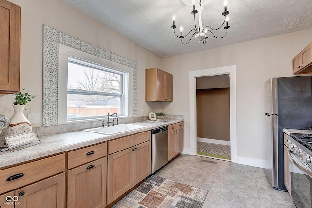 kitchen with a chandelier, a sink, visible vents, light countertops, and appliances with stainless steel finishes