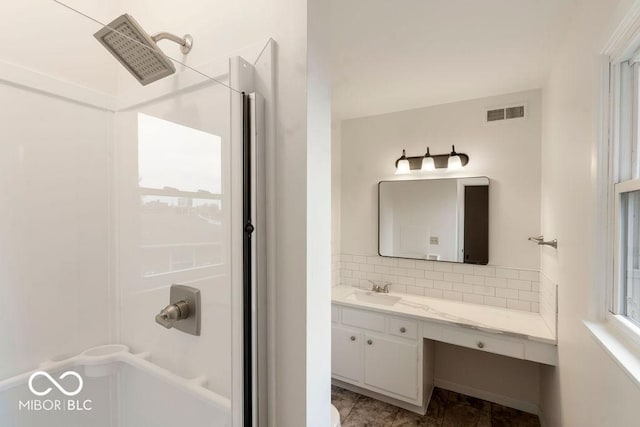 bathroom featuring visible vents, tasteful backsplash, and vanity