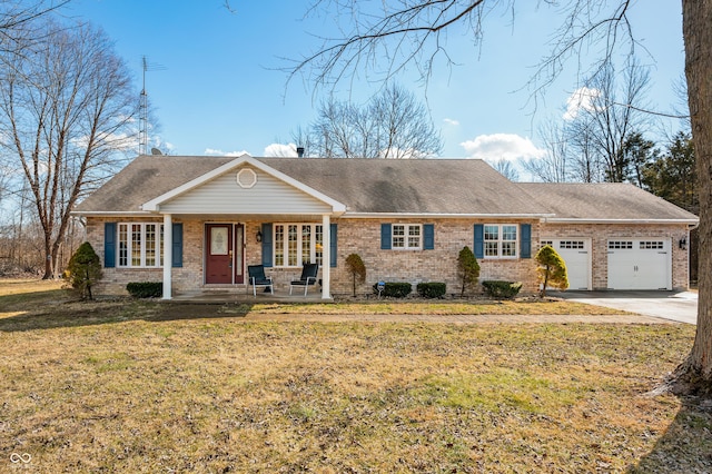 view of front facade with a garage, driveway, a front yard, a porch, and brick siding