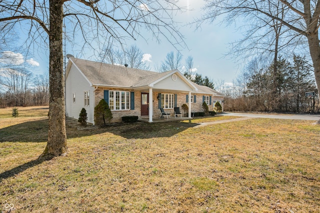 view of front of home with brick siding and a front yard