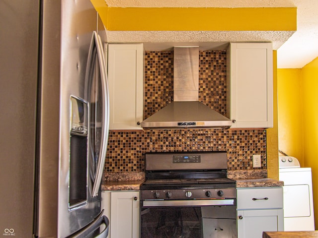 kitchen with stainless steel appliances, white cabinets, wall chimney range hood, tasteful backsplash, and washer / dryer