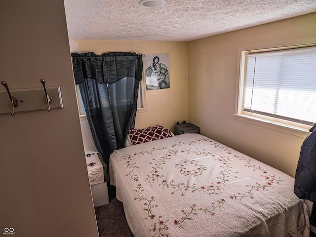 bedroom with a textured ceiling and carpet floors