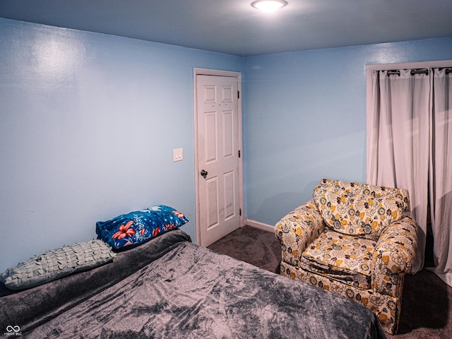 bedroom featuring carpet and baseboards