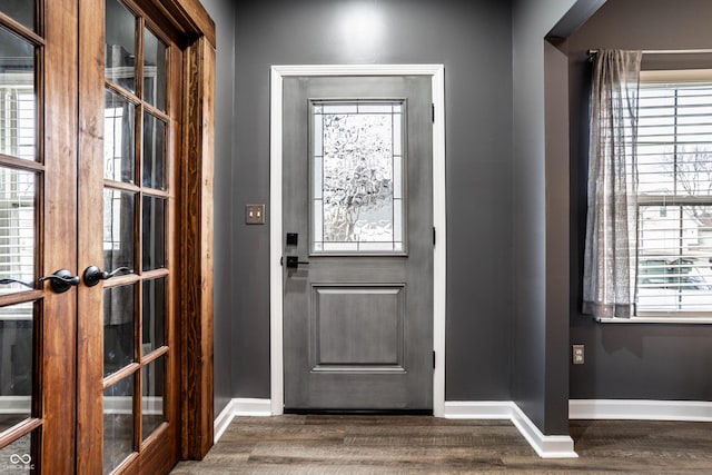 doorway to outside with wood finished floors, baseboards, and french doors