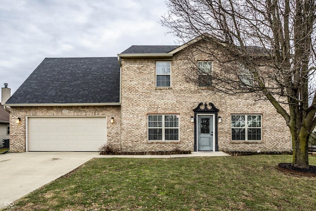 view of front facade with brick siding, a front yard, and an attached garage