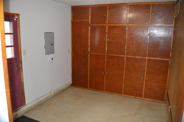 unfurnished bedroom featuring electric panel and light floors