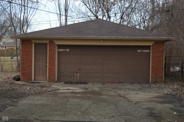 detached garage featuring fence