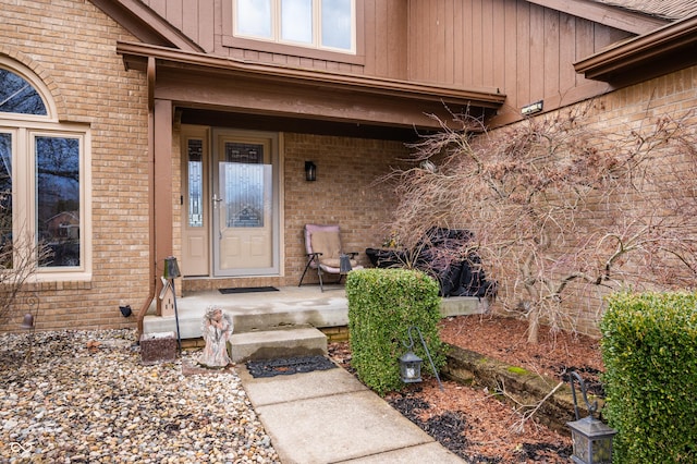 property entrance featuring brick siding