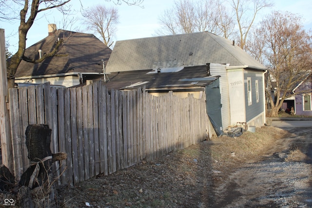 view of side of home featuring fence