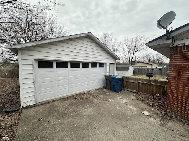 detached garage featuring fence