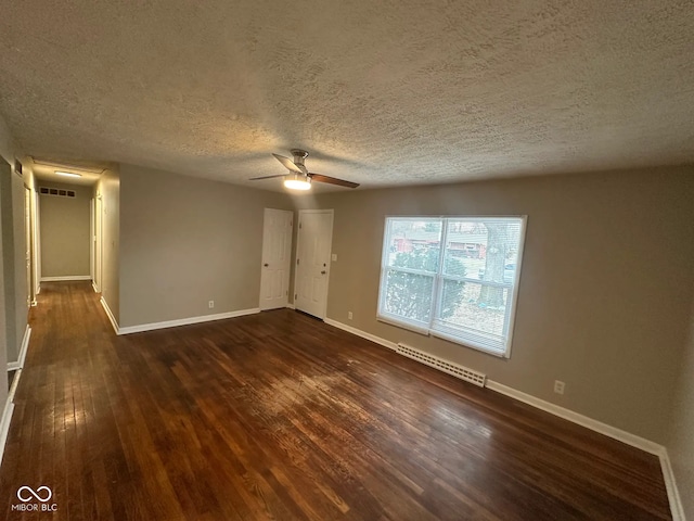 unfurnished room featuring a ceiling fan, dark wood-style flooring, visible vents, and baseboards