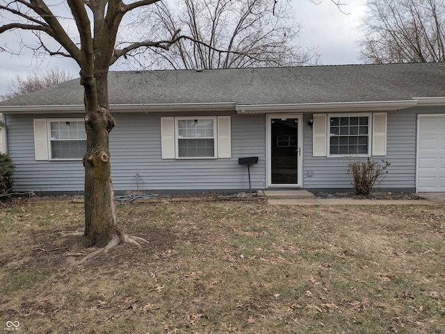 single story home with a shingled roof and an attached garage