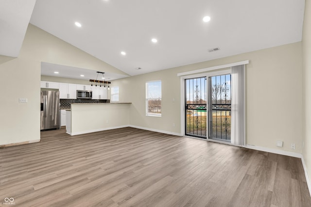 unfurnished living room featuring light wood-style floors, recessed lighting, and baseboards