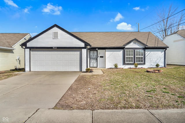 single story home with an attached garage, driveway, a front yard, and brick siding