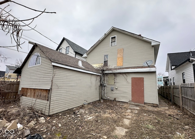 back of house with fence