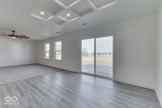 unfurnished room with coffered ceiling, visible vents, and baseboards