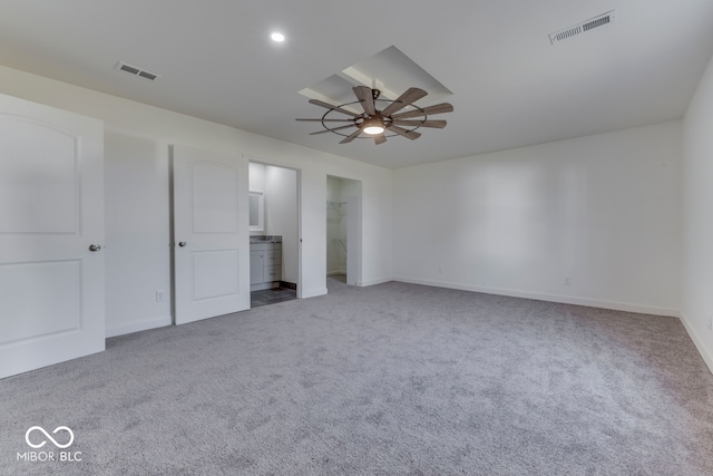 unfurnished bedroom with a ceiling fan, carpet, visible vents, and baseboards