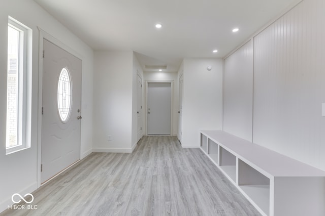 foyer entrance featuring light wood finished floors, baseboards, and recessed lighting