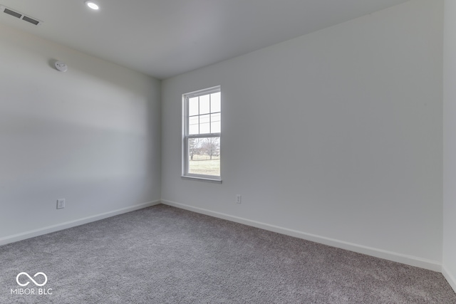 spare room featuring baseboards, visible vents, carpet flooring, and recessed lighting