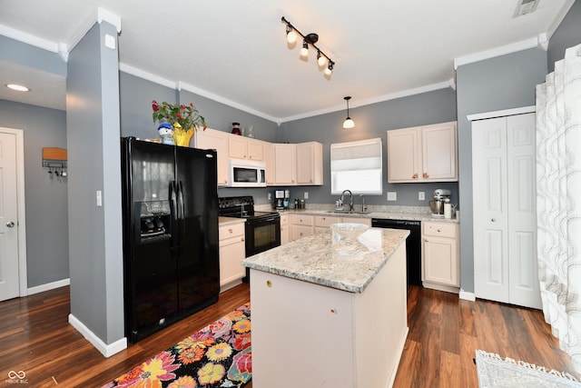 kitchen with ornamental molding, dark wood-style flooring, light stone countertops, black appliances, and a sink