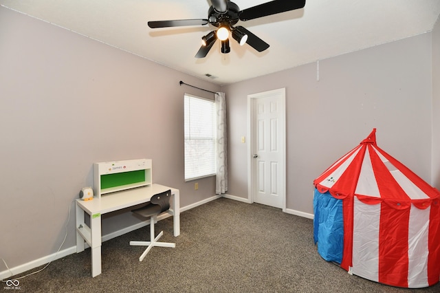 carpeted office with visible vents, baseboards, and ceiling fan