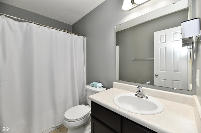 full bathroom with a textured ceiling, vanity, toilet, and tile patterned floors