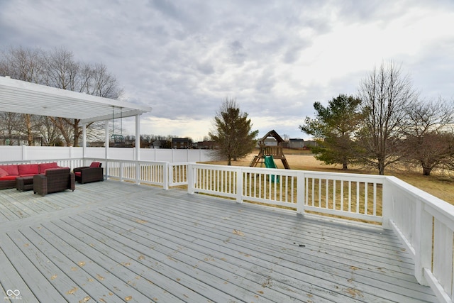 wooden deck featuring fence, outdoor lounge area, and a playground