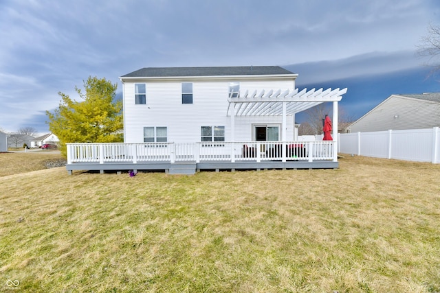 rear view of house featuring a pergola, a lawn, a deck, and fence