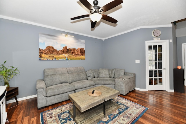 living area with crown molding, baseboards, and wood finished floors