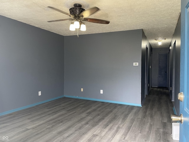 empty room featuring a textured ceiling, baseboards, a ceiling fan, and wood finished floors