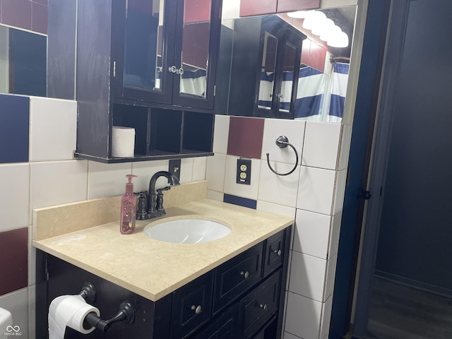 bathroom featuring vanity and tile walls