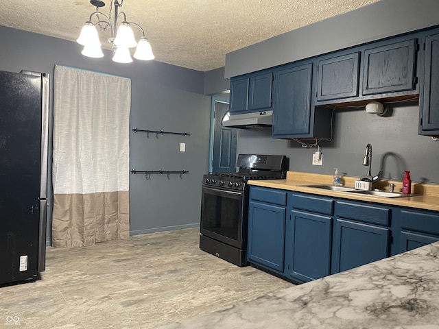 kitchen featuring blue cabinets, under cabinet range hood, a sink, stainless steel appliances, and light countertops