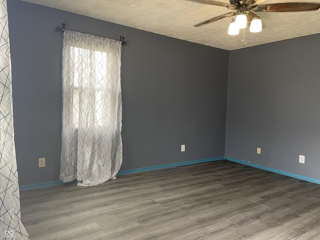 unfurnished room featuring baseboards, a textured ceiling, wood finished floors, and a ceiling fan