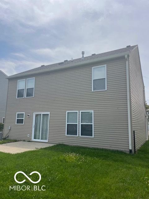 8249 Retreat Ln, Indianapolis, IN 46259 - back of house with a lawn and a patio