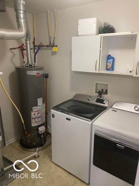 8249 Retreat Ln, Indianapolis, IN 46259 - washroom with water heater, washing machine and clothes dryer, cabinet space, and a textured ceiling