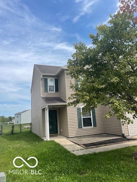 8249 Retreat Ln, Indianapolis, IN 46259 - back of house featuring a gate, fence, a patio, a garage, and a lawn