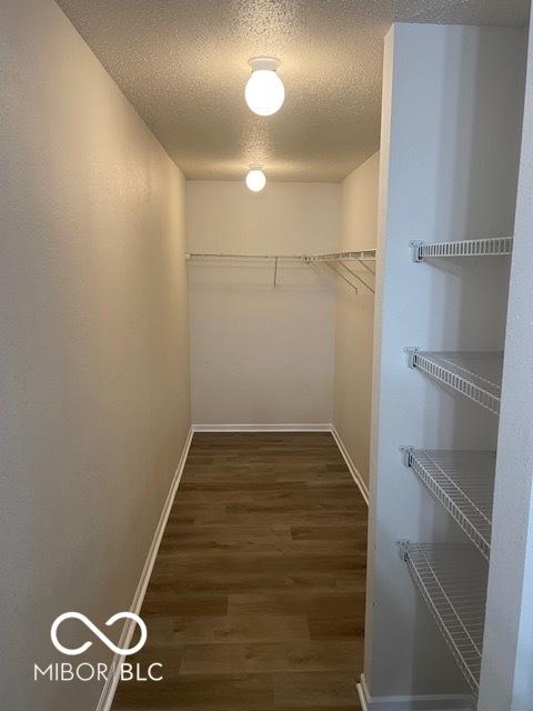 8249 Retreat Ln, Indianapolis, IN 46259 - walk in closet featuring wood finished floors
