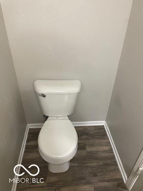 8249 Retreat Ln, Indianapolis, IN 46259 - bathroom with baseboards, wood finished floors, and toilet