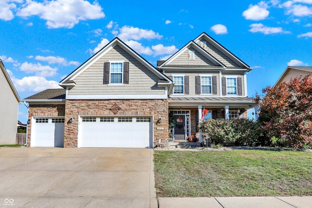 craftsman-style home with driveway, stone siding, and a front lawn