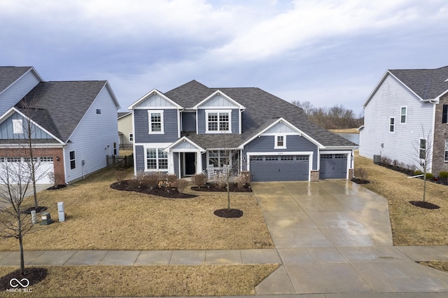 view of front of property featuring board and batten siding, concrete driveway, roof with shingles, and an attached garage