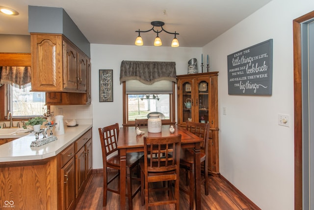 dining room featuring dark wood-type flooring and baseboards