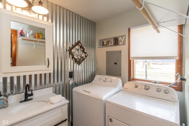 laundry room featuring wallpapered walls, laundry area, electric panel, washing machine and dryer, and a sink